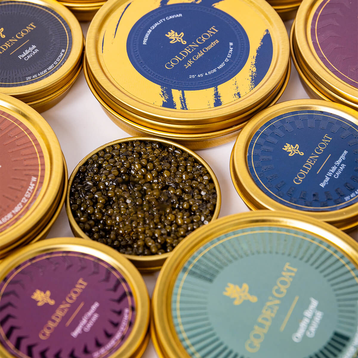 An assortment of various types of caviar on a white backdrop.