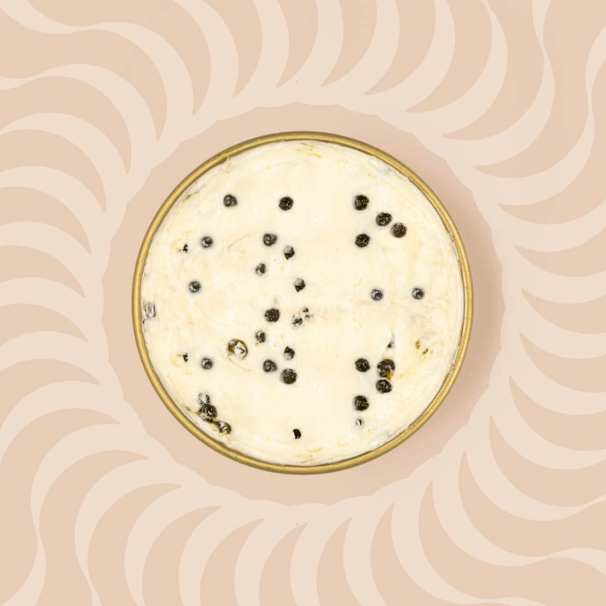 A tin of caviar honey butter with caviar pearls of caviar mixed in.