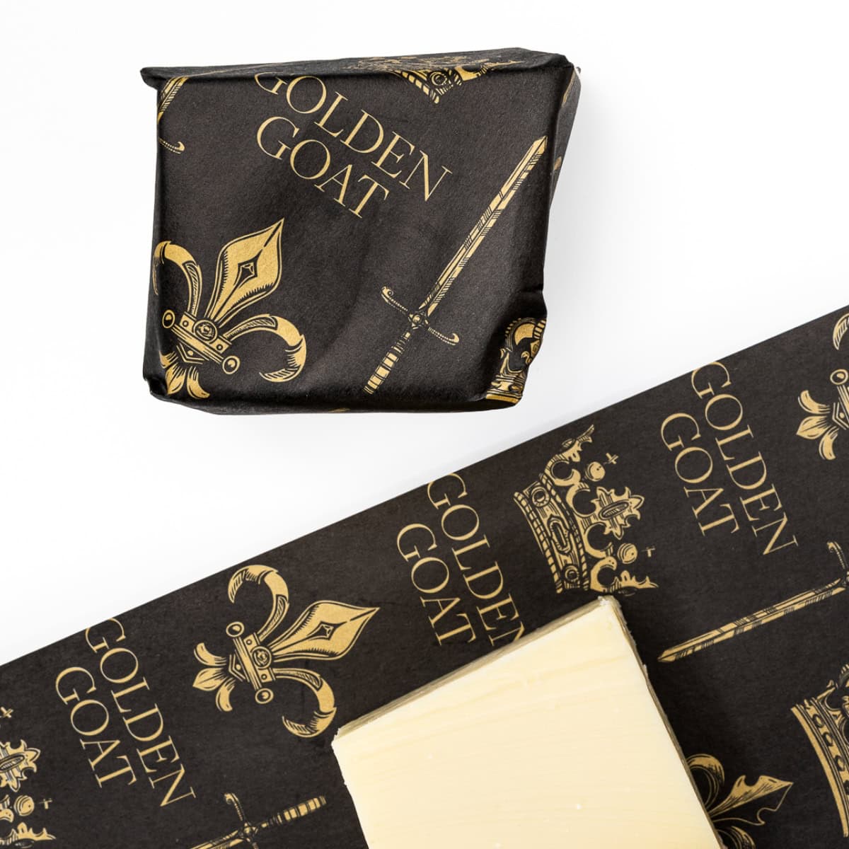 A block of cheese in wrapping paper with golden goat and crown motifs.