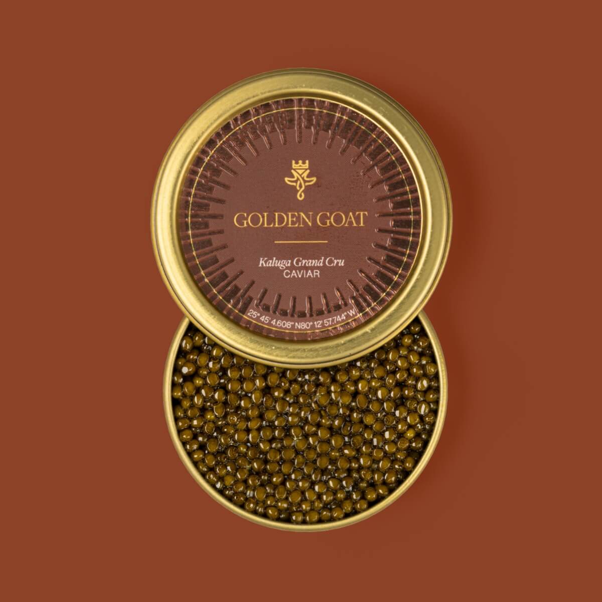 A tin container of Kaluga Grand Cru caviar presented with its lid open, showcasing the golden-brown, firm textured caviar inside.