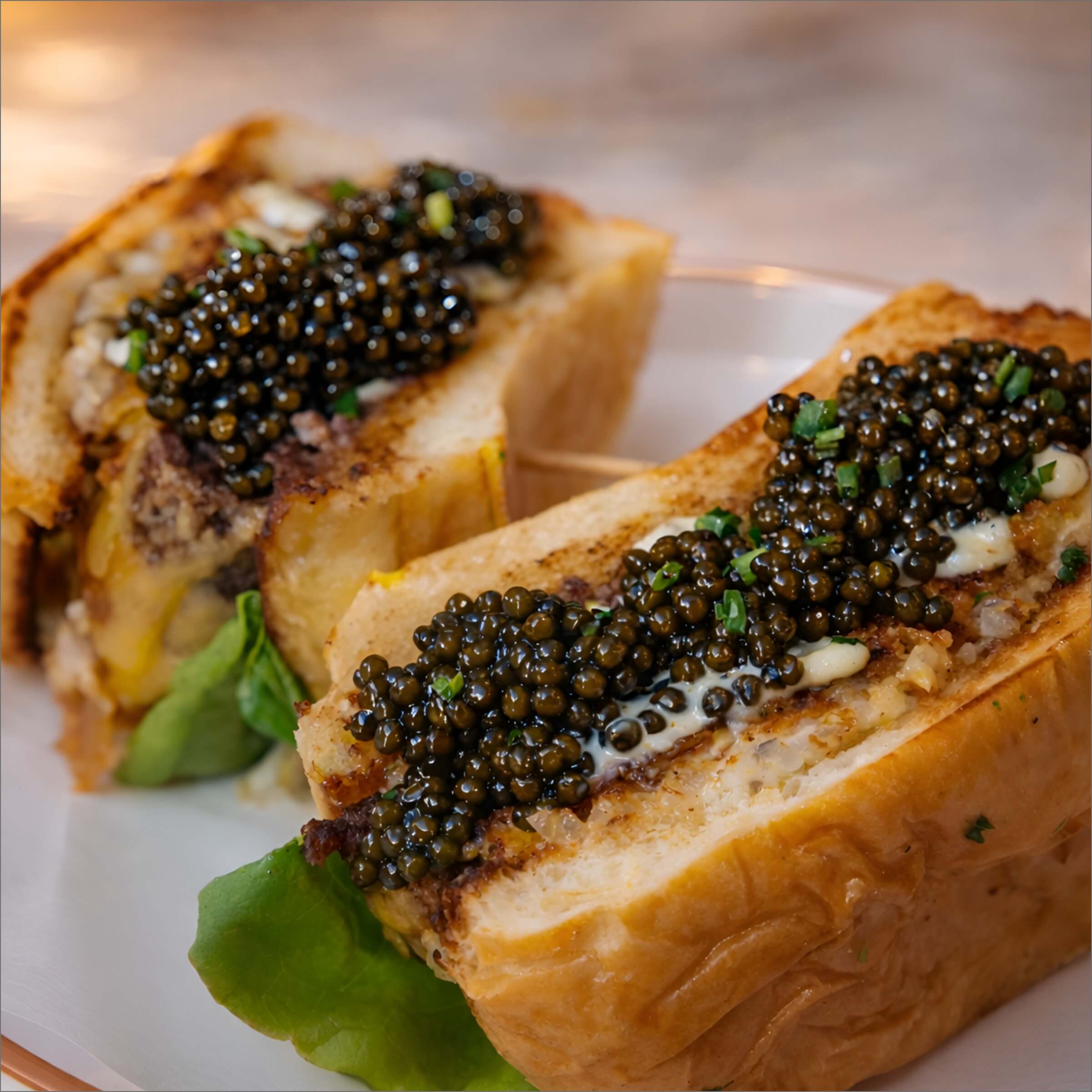 Succulent Burger topped with caviar on a white porcelain plate.
