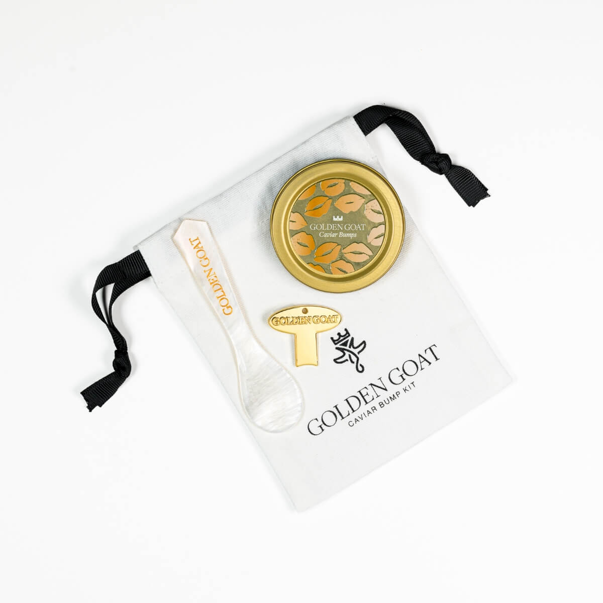 Golden Goat candle and spoon set with branded pouch on a white background